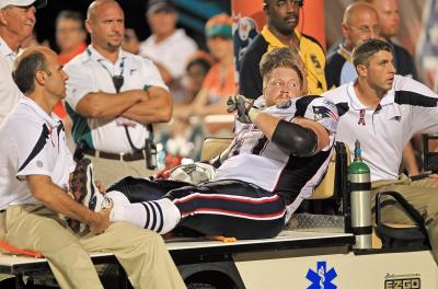 Patriots center Dan Koppen gets carted off after suffering an injury to his ankle during the first half of last night’s season-opening victory against the Dolphins in Miami Gardens, Fla.